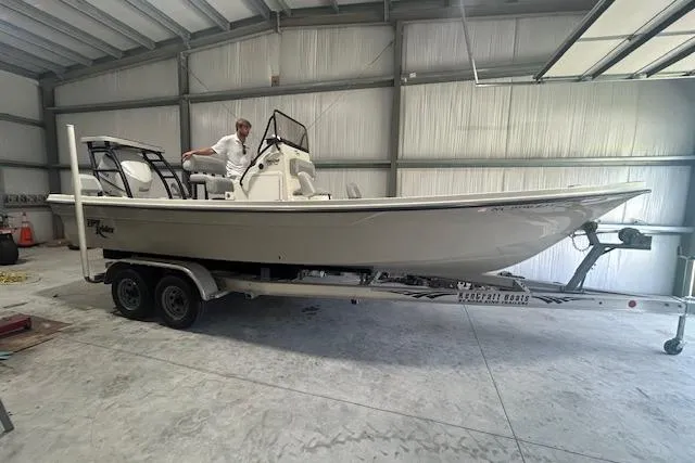 Slide: The Image of 2020 KenCraft 239 Bay Rider boat on trailer in a garage setting. - 2