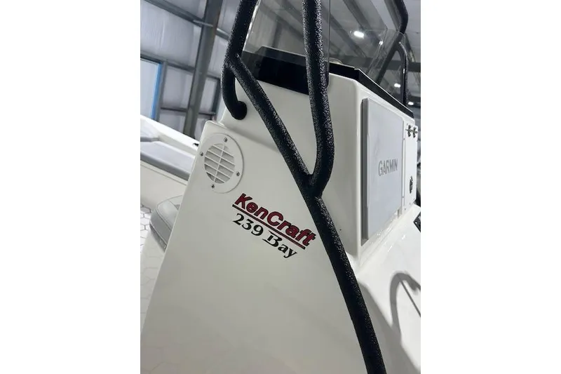 Slide: The Image of 2020 KenCraft 239 Bay Rider boat interior with Garmin equipment in a well-lit showroom. - 21