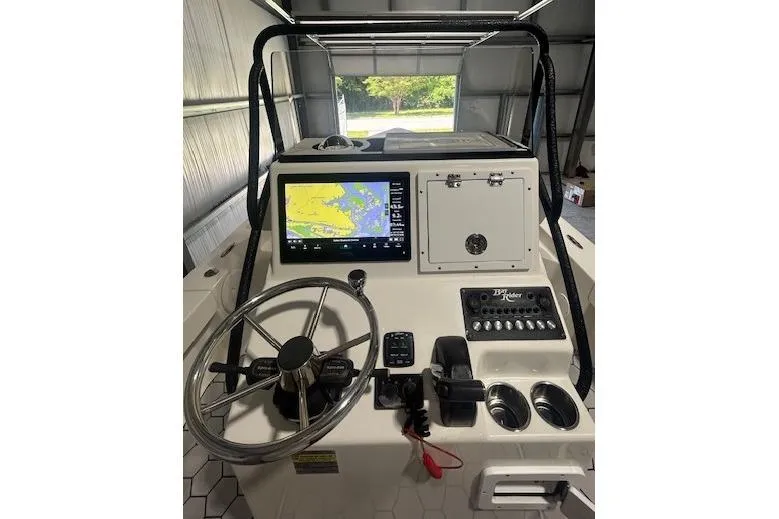 Slide: The Image of 2020 KenCraft 239 Bay Rider boat console with steering wheel and navigation display. - 6