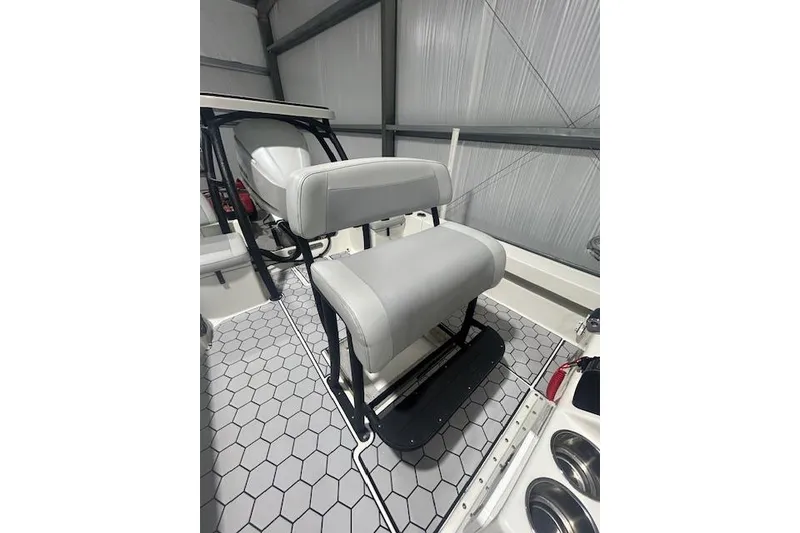Slide: The Image of 2020 KenCraft 239 Bay Rider boat interior with cushioned seating and hexagonal floor design. - 8