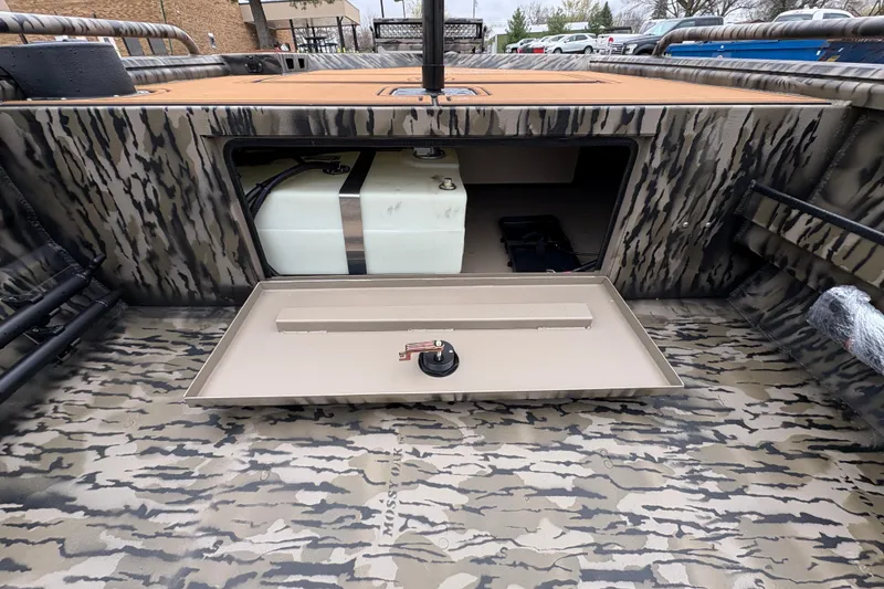 Slide: The Image of 2026 Excel 1860 F4 Pro boat interior with open storage compartment and camouflage design. - 11