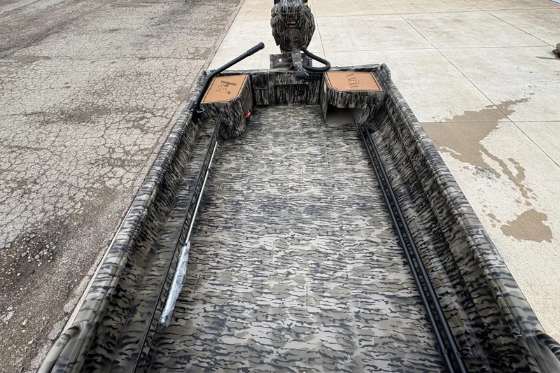 Slide: The Image of 2026 Excel 1860 F4 Pro boat with camouflage design on pavement. - 12