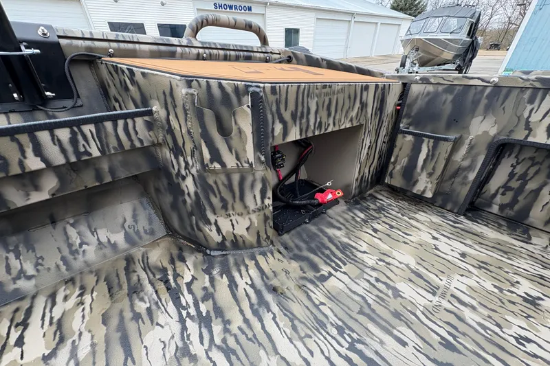 Slide: The Image of 2026 Excel 1860 F4 Pro boat interior with camouflage design and storage compartment. - 16