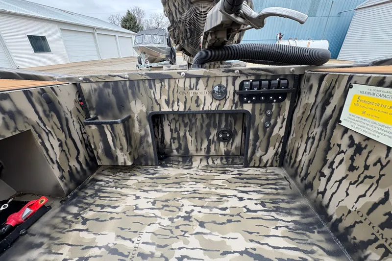 Slide: The Image of Interior of 2026 Excel 1860 F4 Pro boat with camouflage design and control panel. - 18