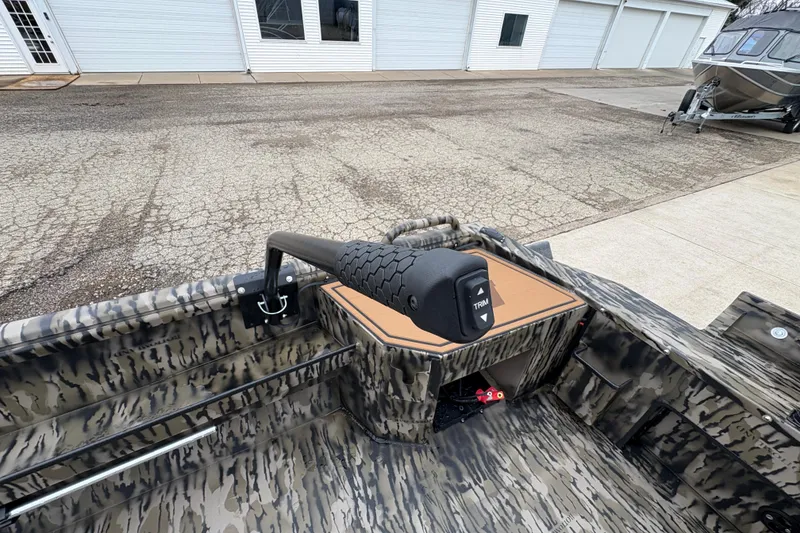 Slide: The Image of 2026 Excel 1860 F4 Pro boat interior with camo design and trim control. - 20