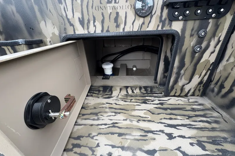 Slide: The Image of Interior view of 2026 Excel 1860 F4 Pro boat with camouflage design and storage compartment. - 23
