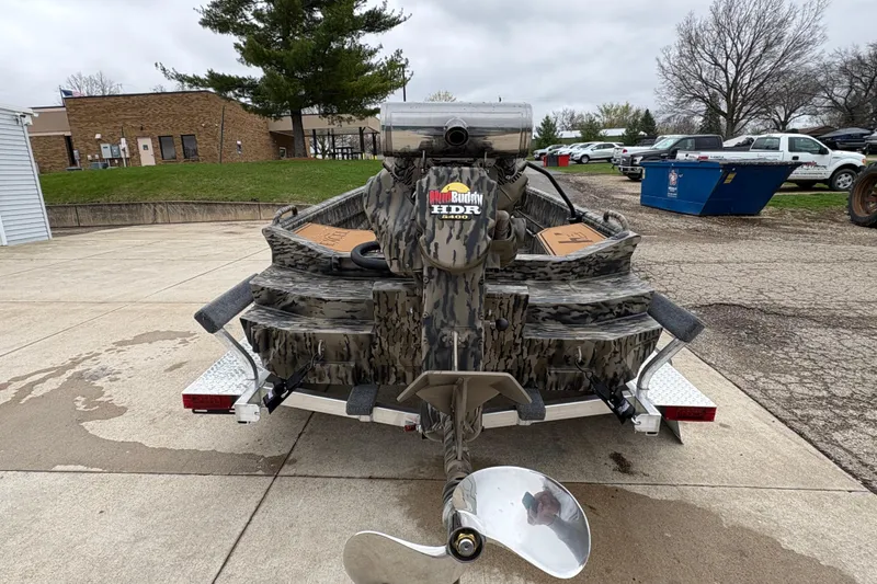 Slide: The Image of 2026 Excel 1860 F4 Pro boat with camo design and powerful motor, parked outdoors. - 3