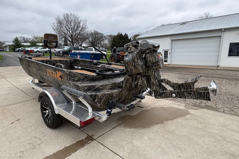 Slide: The Image of Camouflage-patterned Excel 1860 F4 Pro boat on trailer, parked outdoors, 2026 model. - 4