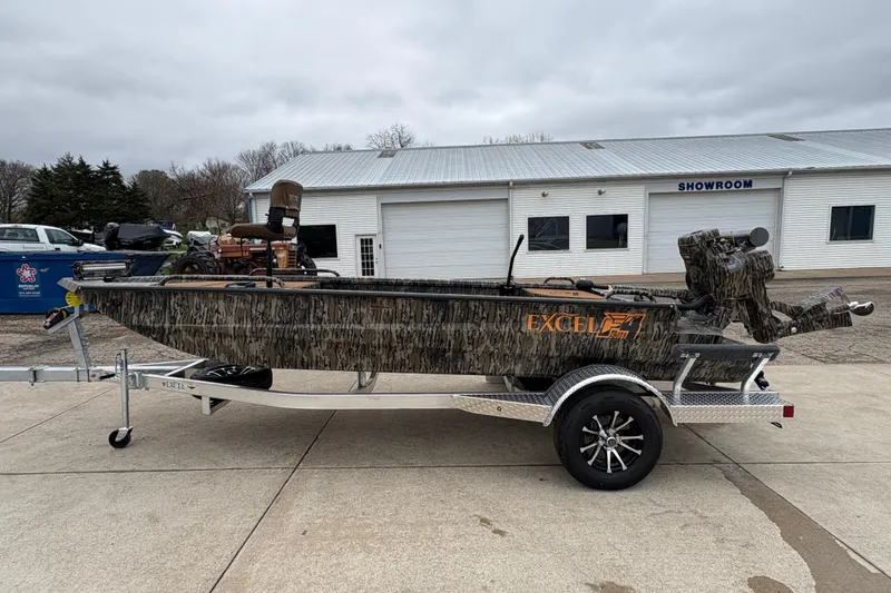 Slide: The Image of 2026 Excel 1860 F4 Pro boat on trailer outside showroom, featuring camouflage design. - 5