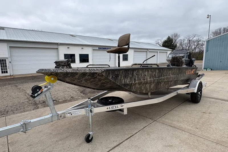 Slide: The Image of 2026 Excel 1860 F4 Pro boat on trailer outside showroom. - 6
