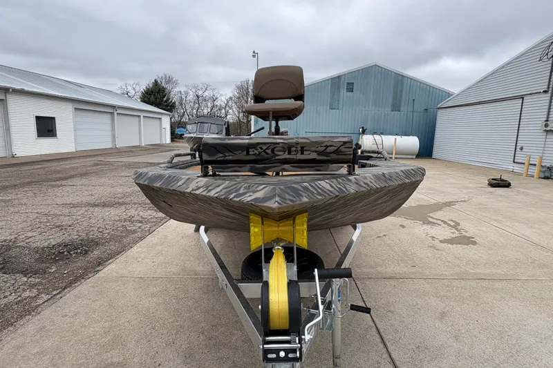 Slide: The Image of 2026 Excel 1860 F4 Pro boat on trailer, parked outdoors near industrial buildings. - 7