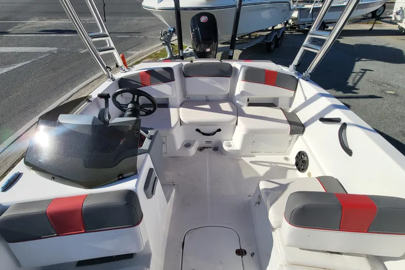 Slide: The Image of 2023 Tahoe T18 boat interior with seating, steering wheel, and windshield in sunlight. - 3