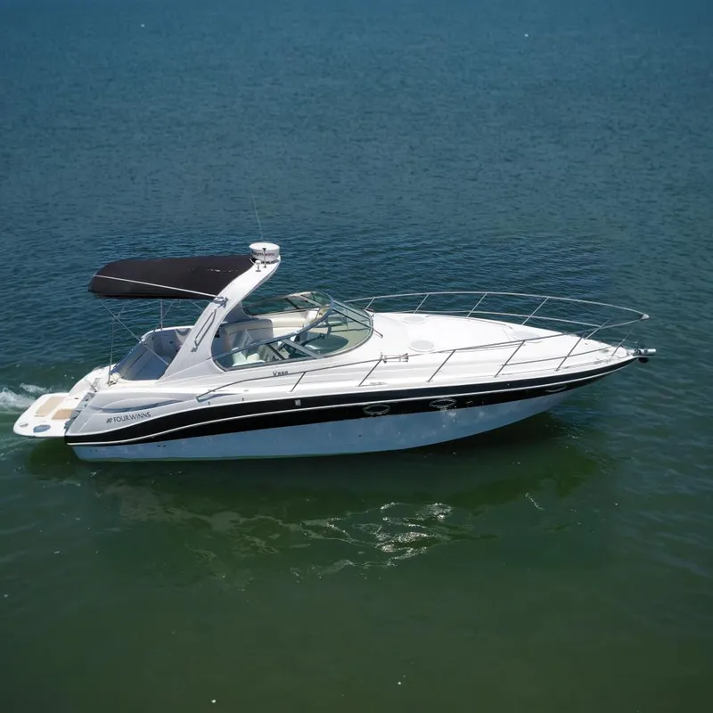 The Image of 2008 Four Winns V358 boat with black canopy cruising on water. - 0
