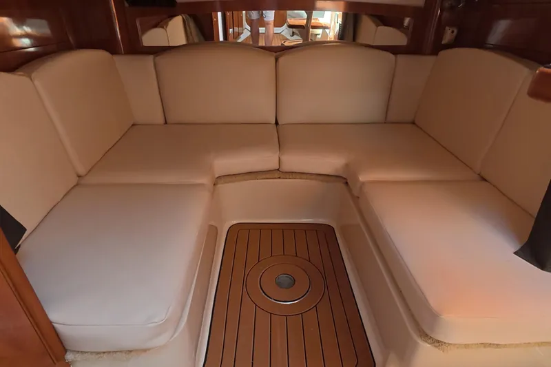 Slide: The Image of 2008 Four Winns V358 yacht interior with beige seating and wooden flooring. - 10