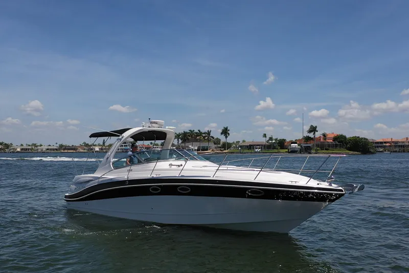 Slide: The Image of 2008 Four Winns V358 boat cruising on a sunny day near coastal homes. - 15