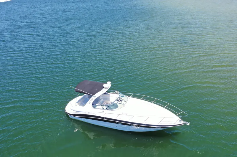 Slide: The Image of 2008 Four Winns V358 boat cruising on clear blue water. - 23