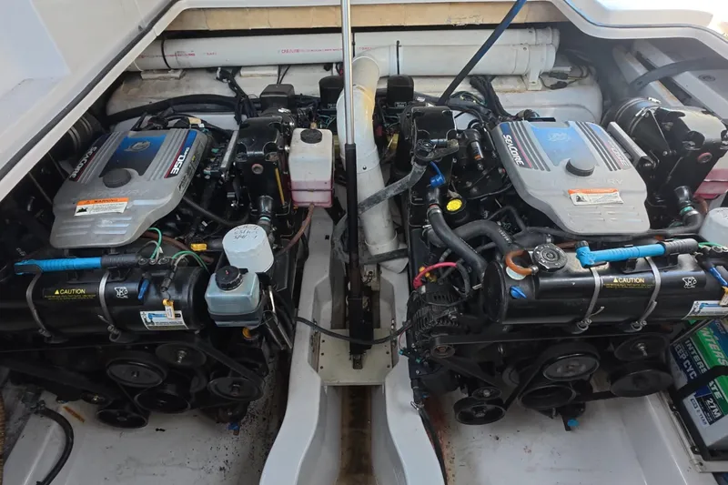 Slide: The Image of Engine compartment of a 2008 Four Winns V358 boat, featuring dual Mercury engines. - 28