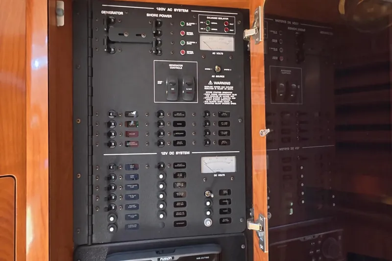 Slide: The Image of Electrical control panel on a 2008 Four Winns V358 boat, featuring AC and DC systems. - 34