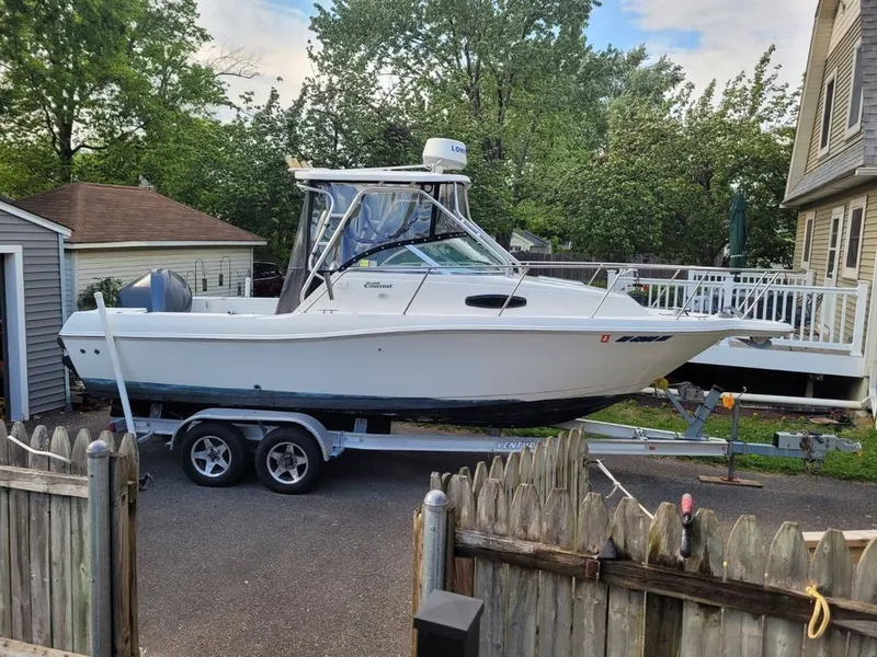 The Image of 2003 Wellcraft 240 Coastal boat on trailer in driveway. - 0
