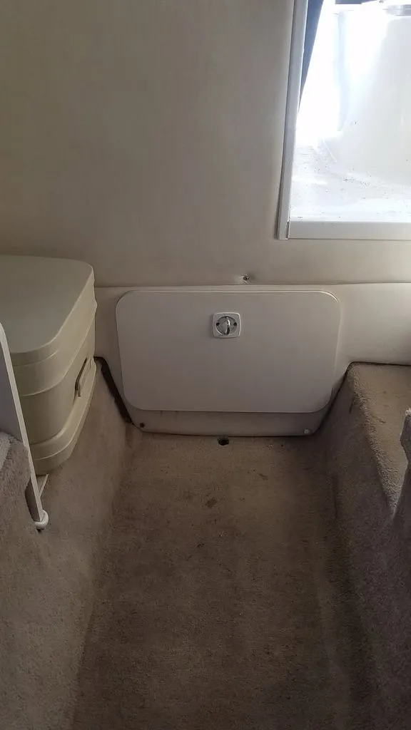 Slide: The Image of Interior of a 2003 Wellcraft 240 Coastal boat with carpeted flooring. - 10