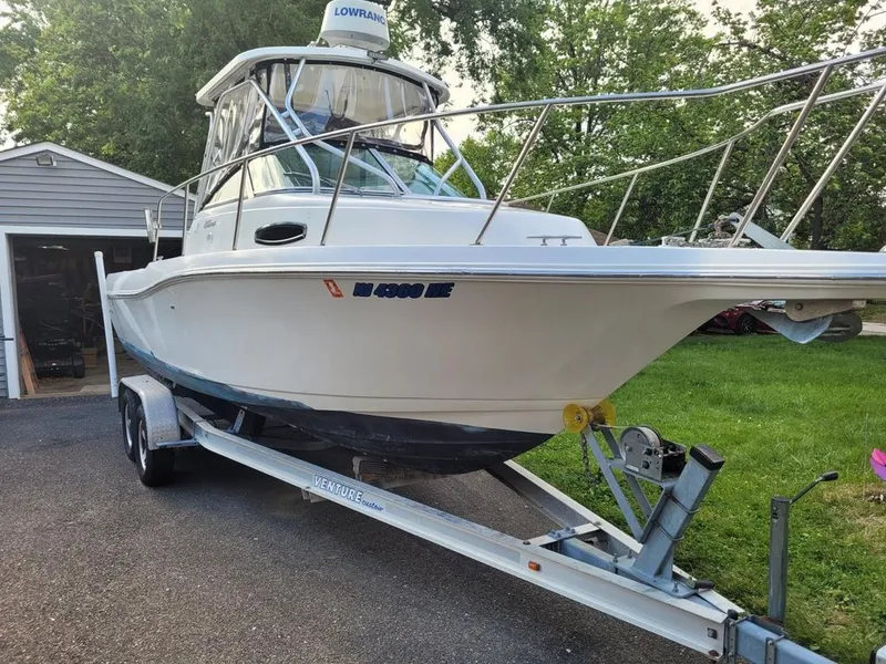 Slide: The Image of 2003 Wellcraft 240 Coastal boat on trailer parked outdoors. - 3