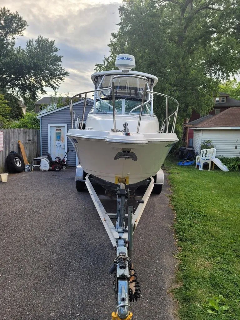 Slide: The Image of 2003 Wellcraft 240 Coastal boat on trailer in backyard. - 4