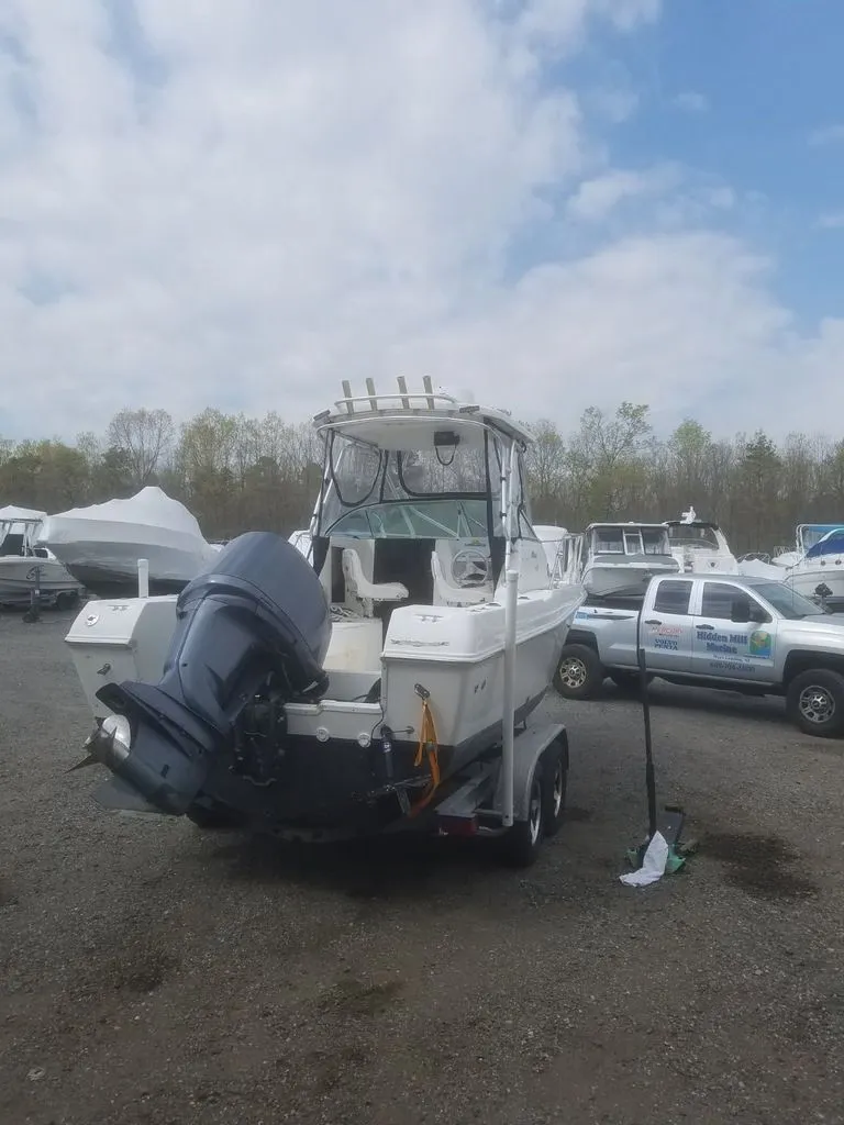 Slide: The Image of 2003 Wellcraft 240 Coastal boat parked on trailer outdoors. - 5