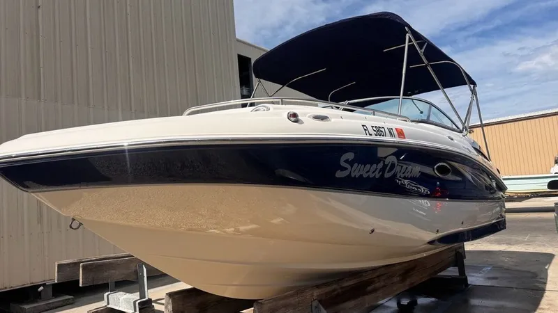 The Image of 2008 Hurricane Sundeck boat on a trailer outdoors. - 0