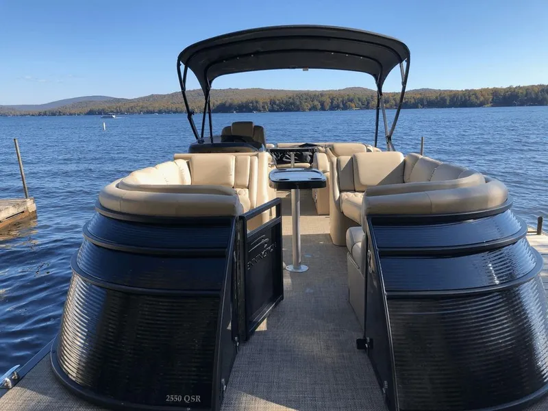 The Image of 2014 Bennington 2550QSR pontoon boat on a serene lake. - 0