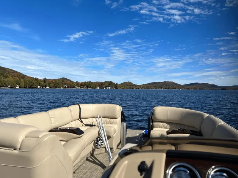 Slide: The Image of Bennington 2550QSR pontoon boat on a serene lake, 2014 model. - 1