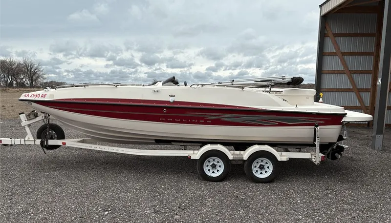 The Image of 2008 Bayliner Deck Boat 217SD on trailer, side view. - 0