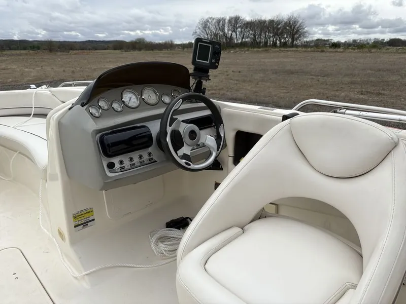 Slide: The Image of Interior of a 2008 Bayliner Deck Boat 217SD with steering console. - 3