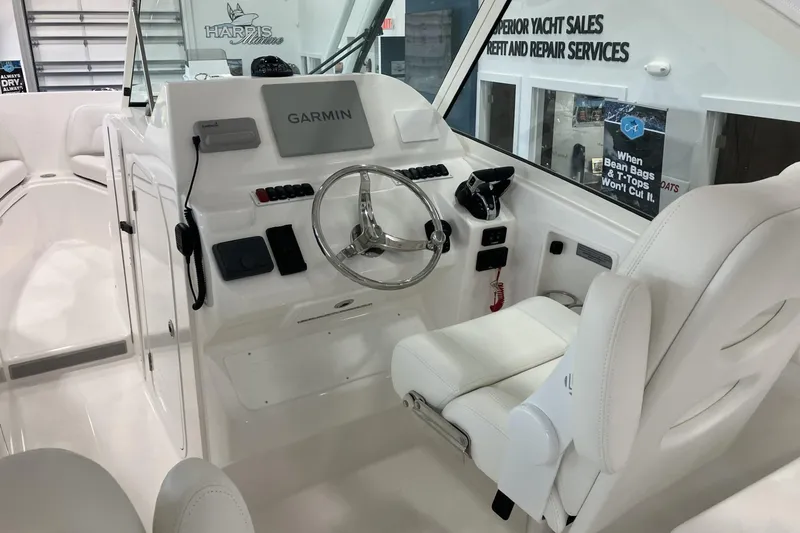 Slide: The Image of 2026 Albemarle 27 Dual Console boat interior with Garmin navigation system and white seating. - 15