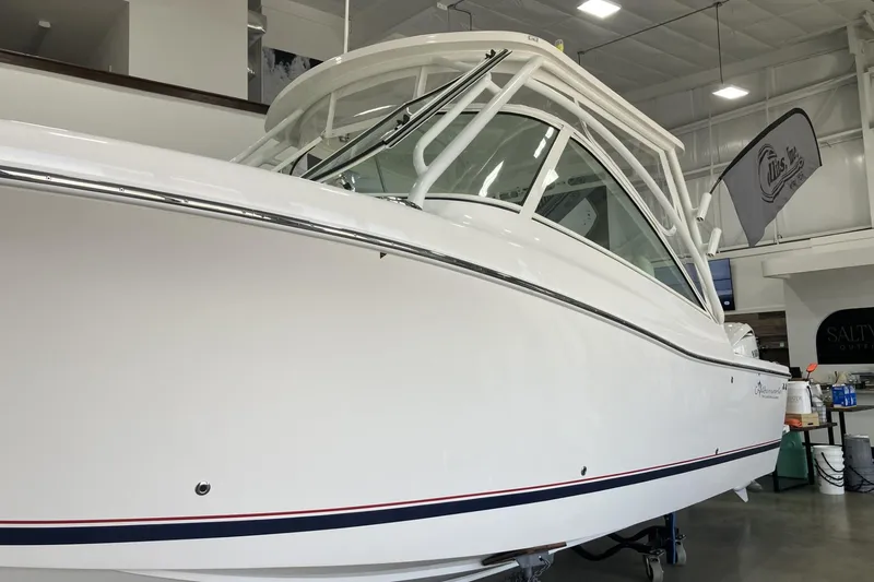 Slide: The Image of 2026 Albemarle 27 Dual Console boat in showroom, showcasing sleek design and modern features. - 17