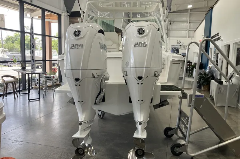 Slide: The Image of 2026 Albemarle 27 Dual Console with twin Yamaha 200 engines in showroom. - 3
