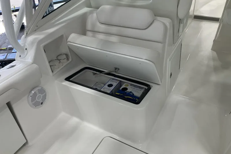 Slide: The Image of 2026 Albemarle 27 Dual Console boat interior with storage compartment open. - 8