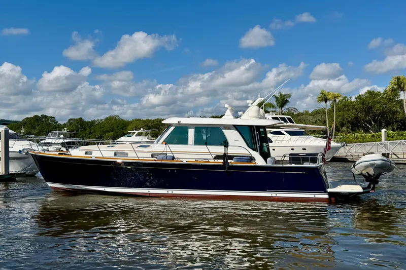 The Image of 2016 Sabre 48 Salon Express yacht docked on a sunny day with blue skies. - 0