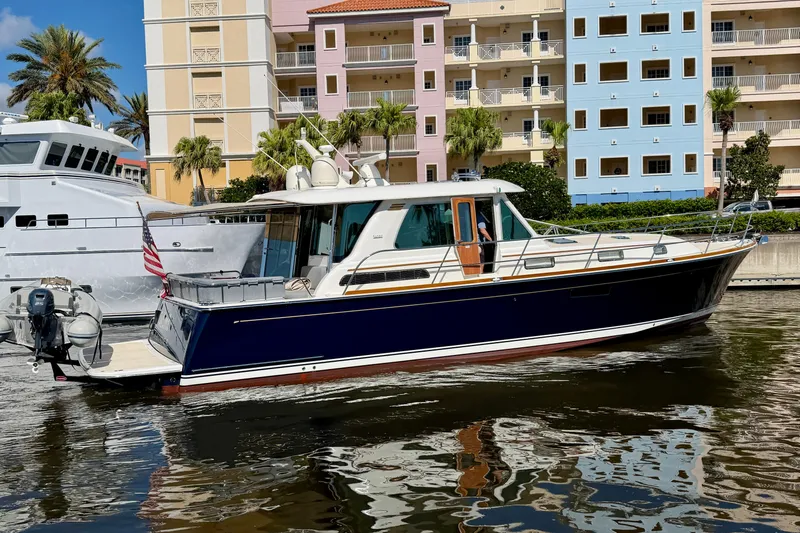 Slide: The Image of 2016 Sabre 48 Salon Express yacht docked near colorful buildings. - 1