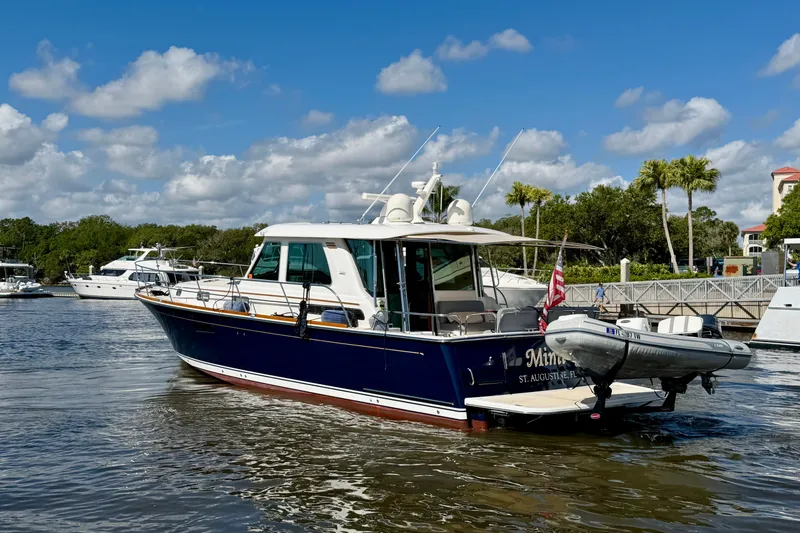 Slide: The Image of 2016 Sabre 48 Salon Express yacht docked in sunny marina, blue sky background. - 10