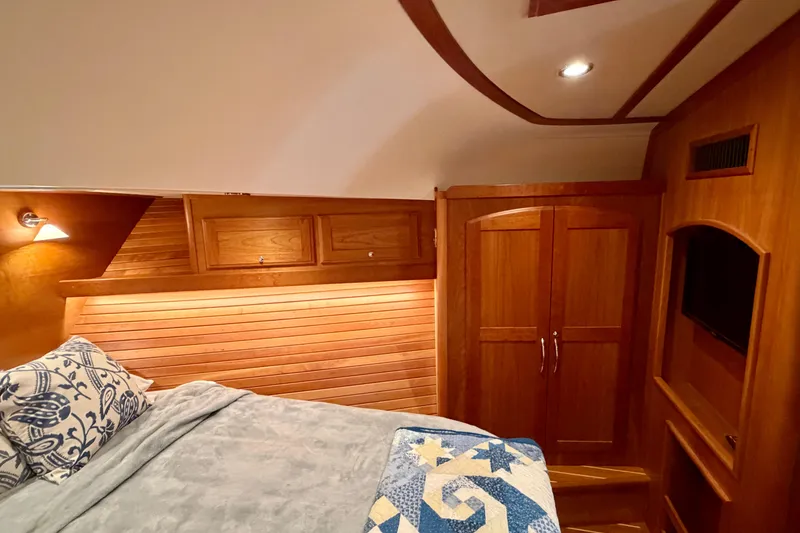 Slide: The Image of Luxurious 2016 Sabre 48 Salon Express cabin with wood paneling and cozy bedding. - 24