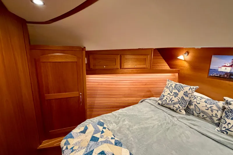Slide: The Image of Luxurious 2016 Sabre 48 Salon Express cabin with wooden interior and cozy bedding. - 25