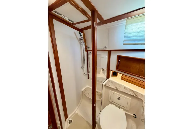 Slide: The Image of Bathroom interior of 2016 Sabre 48 Salon Express yacht, featuring shower and wooden accents. - 26