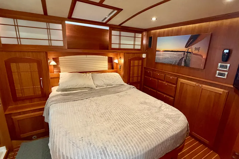 Slide: The Image of Luxurious 2016 Sabre 48 Salon Express bedroom with wood paneling and cozy bedding. - 28