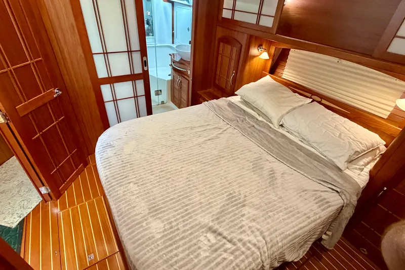 Slide: The Image of Luxurious bedroom interior of 2016 Sabre 48 Salon Express yacht with wooden accents. - 29