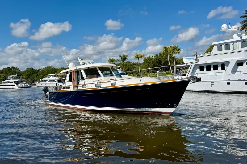 Slide: The Image of 2016 Sabre 48 Salon Express yacht cruising on a sunny day with other boats nearby. - 3