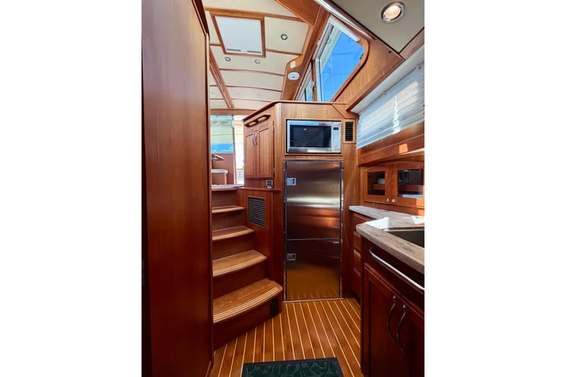 Slide: The Image of Interior of 2016 Sabre 48 Salon Express yacht with wooden cabinetry and modern appliances. - 36