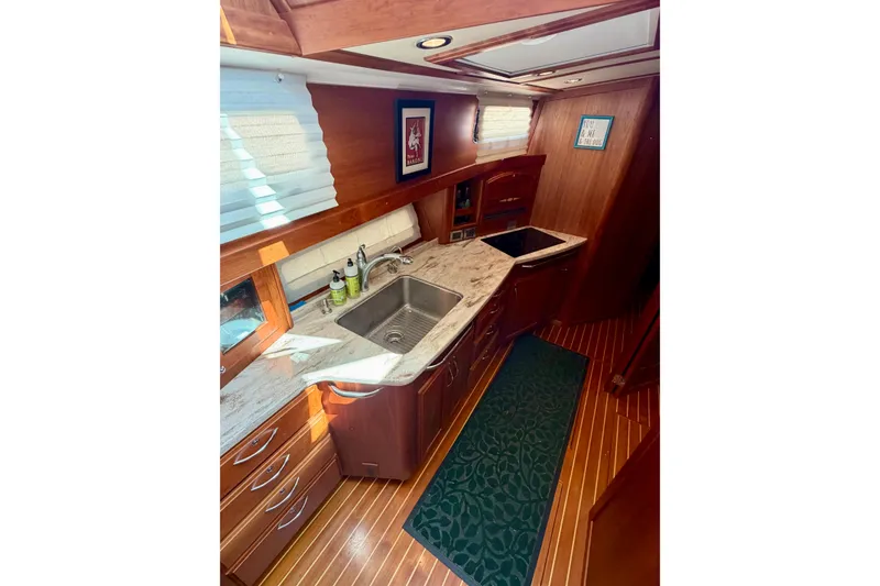 Slide: The Image of 2016 Sabre 48 Salon Express galley with wood cabinetry and marble countertops. - 37