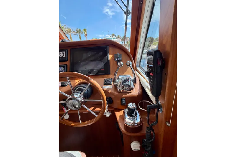 Slide: The Image of 2016 Sabre 48 Salon Express helm with steering wheel and navigation controls. - 41