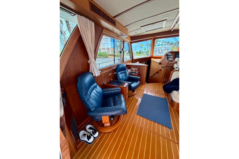 Slide: The Image of Interior of 2016 Sabre 48 Salon Express yacht with blue leather chairs and wooden flooring. - 45