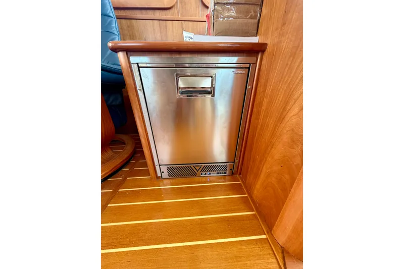Slide: The Image of Stainless steel fridge in 2016 Sabre 48 Salon Express yacht interior with wooden flooring. - 46
